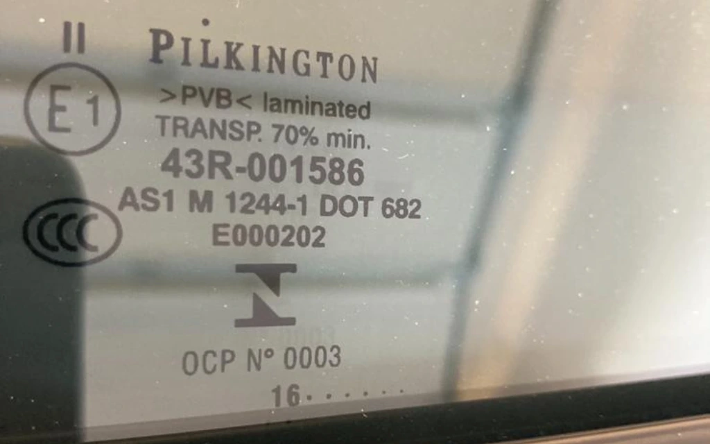 VLT measurement gauge held against a car window during a roadside check