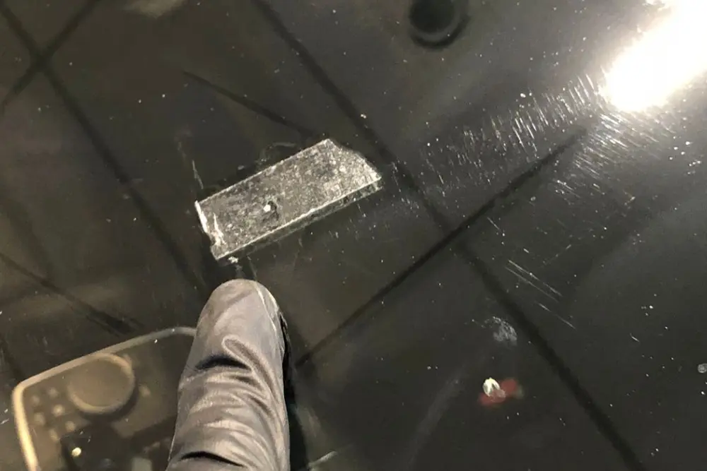 Side-by-side photo of a small windscreen chip and a long crack